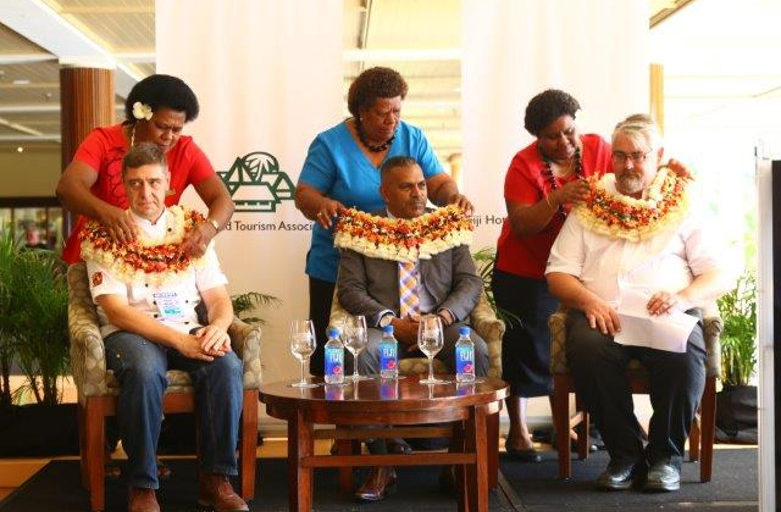 Garlanding of the official party – L-R Chef Jean Marc Ruzzene, Vice President Fiji Chefs Association, The Hon Minister F Koya and Matthew Gillespie, Vice President Fiji Hotel & Tourism Association